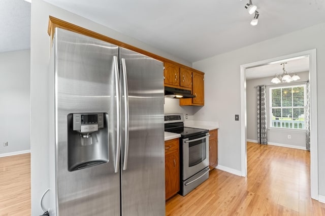 232 Elmwood Dr, Murfreesboro, TN 37128 - kitchen featuring stainless steel appliances, under cabinet range hood, brown cabinets, light wood-style floors, and light countertops