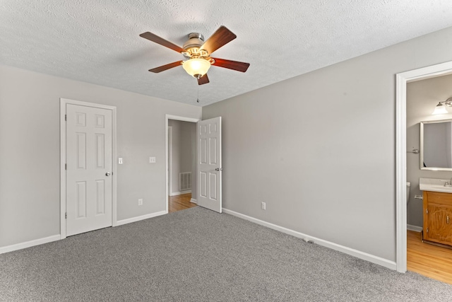 232 Elmwood Dr, Murfreesboro, TN 37128 - unfurnished bedroom with light carpet, a textured ceiling, connected bathroom, and a ceiling fan