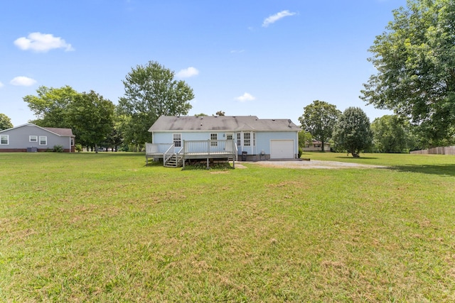 232 Elmwood Dr, Murfreesboro, TN 37128 - rear view of house featuring dirt driveway, an attached garage, a deck, and a lawn
