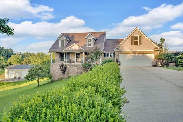 268 Crest Dr, Lynchburg, TN 37352 - new england style home featuring brick siding, covered porch, a garage, and concrete driveway