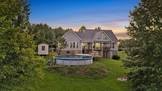 268 Crest Dr, Lynchburg, TN 37352 - back of house with a shed, a lawn, an outdoor pool, and a deck