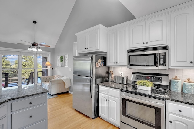268 Crest Dr, Lynchburg, TN 37352 - kitchen featuring appliances with stainless steel finishes, a ceiling fan, tasteful backsplash, white cabinetry, and high vaulted ceiling