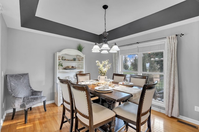 268 Crest Dr, Lynchburg, TN 37352 - dining area featuring a tray ceiling, light wood finished floors, and a chandelier