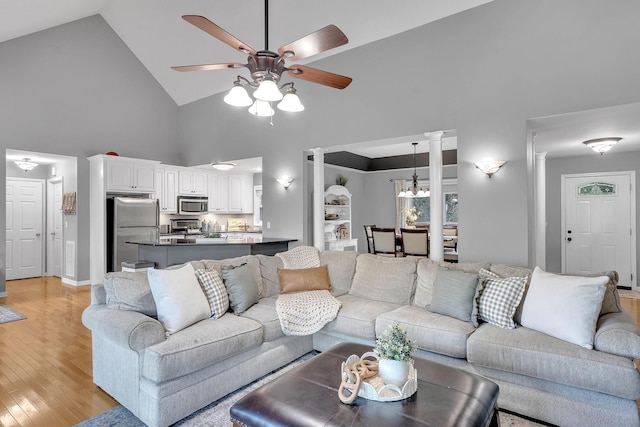 268 Crest Dr, Lynchburg, TN 37352 - living room featuring high vaulted ceiling, ceiling fan, ornate columns, and light wood-type flooring