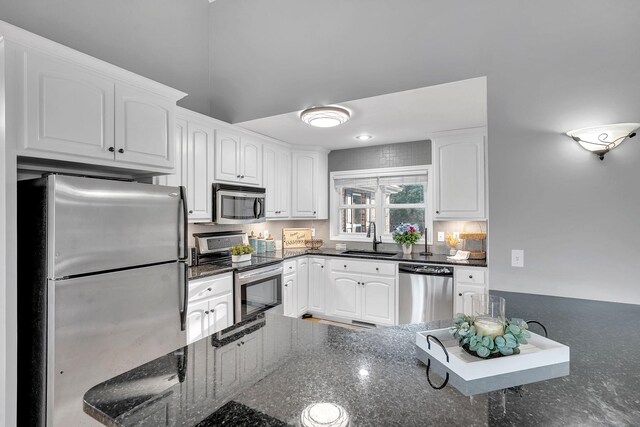 268 Crest Dr, Lynchburg, TN 37352 - kitchen featuring stainless steel appliances, white cabinetry, and dark stone countertops