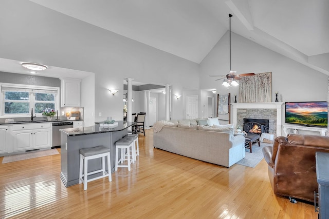 268 Crest Dr, Lynchburg, TN 37352 - living room with light wood-style floors, ceiling fan, high vaulted ceiling, and a fireplace