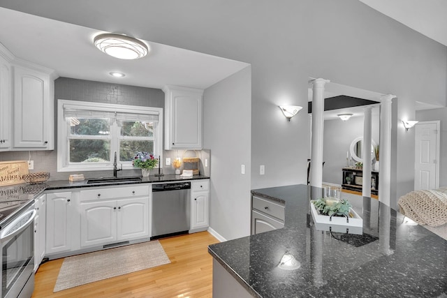 268 Crest Dr, Lynchburg, TN 37352 - kitchen with stainless steel appliances, ornate columns, light wood-style flooring, and tasteful backsplash