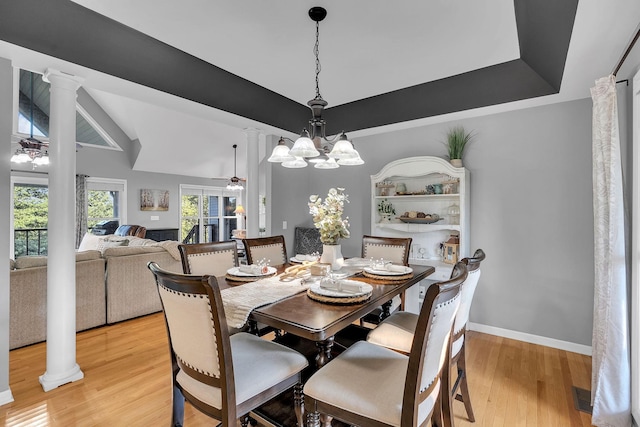 268 Crest Dr, Lynchburg, TN 37352 - dining area with decorative columns, light wood-type flooring, a ceiling fan, and a chandelier