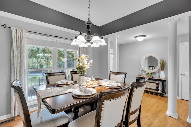268 Crest Dr, Lynchburg, TN 37352 - dining space with decorative columns, a chandelier, and light wood finished floors