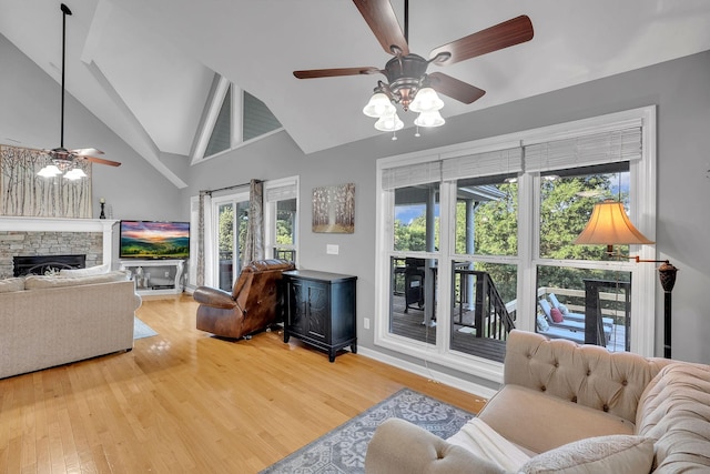 268 Crest Dr, Lynchburg, TN 37352 - living area featuring a ceiling fan, wood finished floors, a fireplace, and high vaulted ceiling