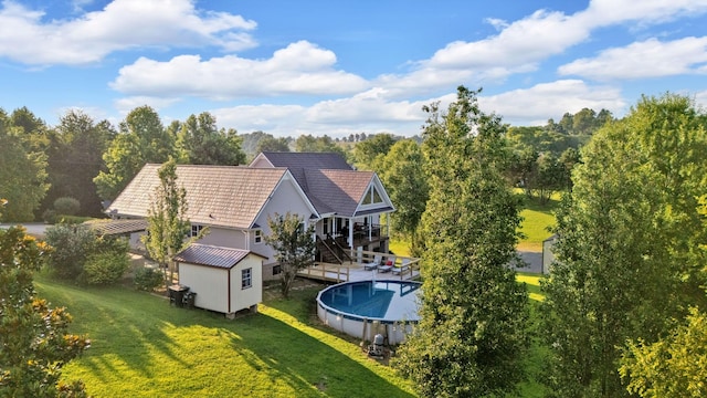 268 Crest Dr, Lynchburg, TN 37352 - back of property featuring a storage shed, a lawn, and an outdoor pool
