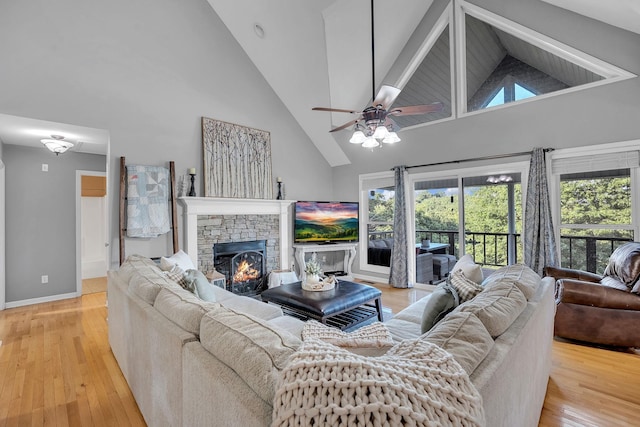 268 Crest Dr, Lynchburg, TN 37352 - living room featuring high vaulted ceiling, wood finished floors, a fireplace, and a ceiling fan