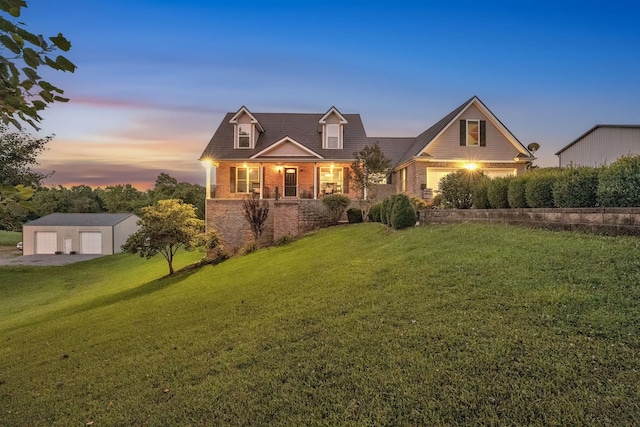 268 Crest Dr, Lynchburg, TN 37352 - cape cod home featuring brick siding, a front lawn, an outbuilding, and a garage
