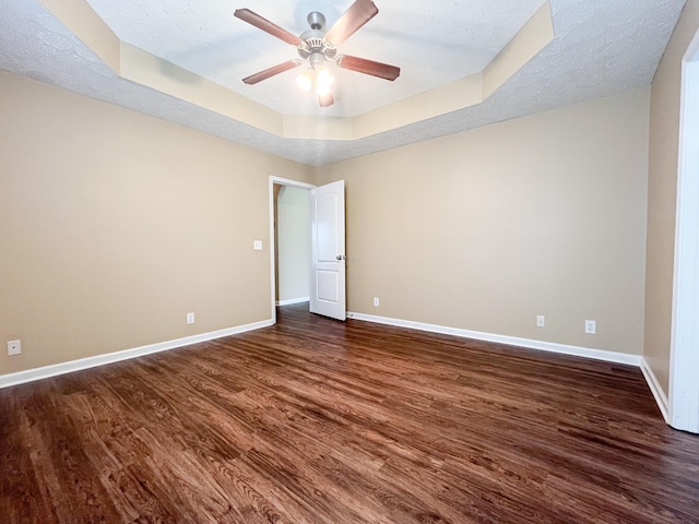 2763 Ridgepole Dr, Clarksville, TN 37040 - spare room with dark wood-style flooring, a raised ceiling, a ceiling fan, and a textured ceiling