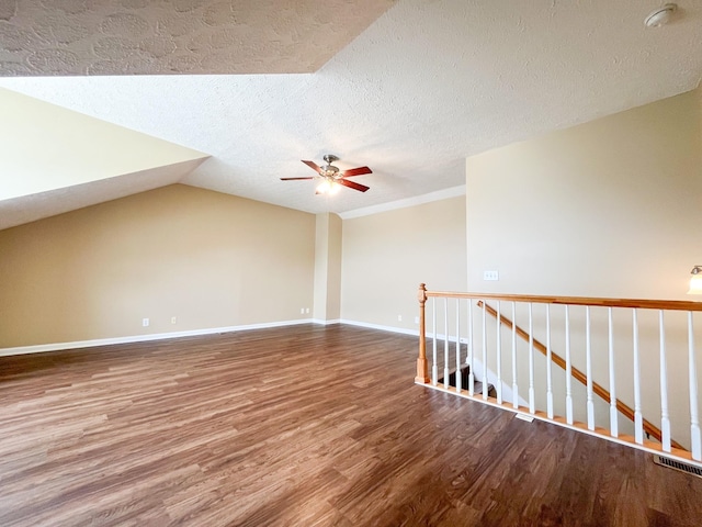 2763 Ridgepole Dr, Clarksville, TN 37040 - spare room featuring wood finished floors, a textured ceiling, ceiling fan, a smoke detector, and vaulted ceiling
