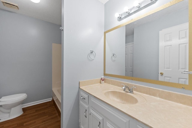 3357 Oak Trees Ct, Antioch, TN 37013 - bathroom featuring vanity, wood finished floors, a tub, and a textured ceiling