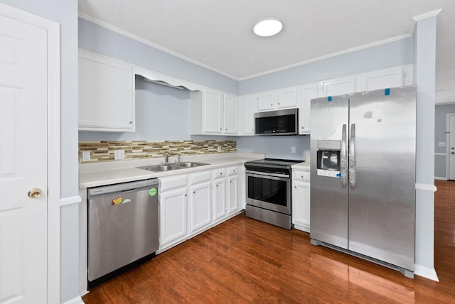 3357 Oak Trees Ct, Antioch, TN 37013 - kitchen with stainless steel appliances, ornamental molding, light countertops, white cabinets, and dark wood-style flooring