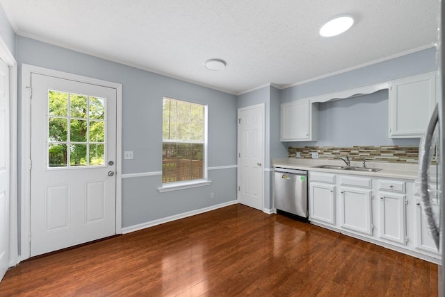 3357 Oak Trees Ct, Antioch, TN 37013 - kitchen with stainless steel dishwasher, light countertops, dark wood-type flooring, decorative backsplash, and white cabinets
