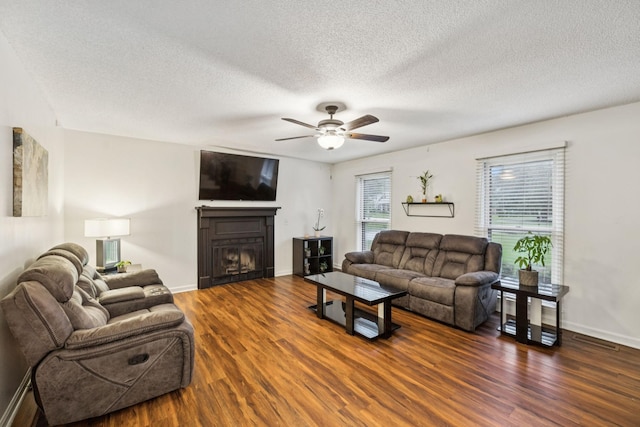 4651 Cynthia Ln, Murfreesboro, TN 37127 - living room featuring wood finished floors, a ceiling fan, a fireplace, and a textured ceiling