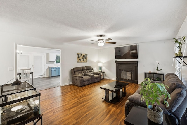 4651 Cynthia Ln, Murfreesboro, TN 37127 - living area featuring a ceiling fan, wood finished floors, a glass covered fireplace, and a textured ceiling