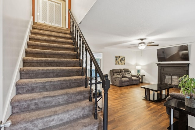 4651 Cynthia Ln, Murfreesboro, TN 37127 - staircase featuring wood finished floors, a glass covered fireplace, and ceiling fan