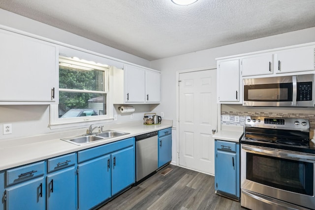 4651 Cynthia Ln, Murfreesboro, TN 37127 - kitchen featuring stainless steel appliances, blue cabinets, dark wood-style flooring, light countertops, and a textured ceiling
