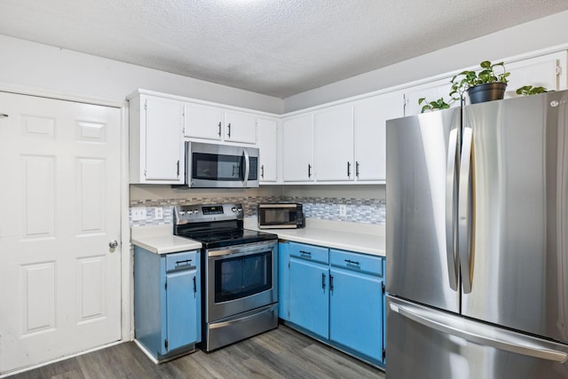 4651 Cynthia Ln, Murfreesboro, TN 37127 - kitchen with appliances with stainless steel finishes, blue cabinets, light countertops, dark wood-type flooring, and a textured ceiling