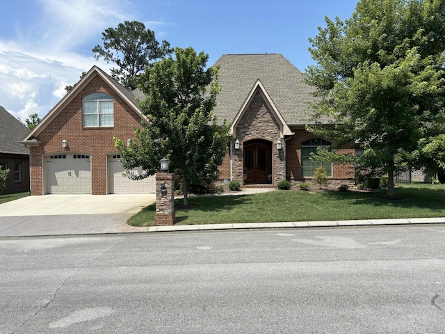 8982 Rostis Ln, Chattanooga, TN 37421 - view of front of house featuring a garage, driveway, a front yard, and brick siding