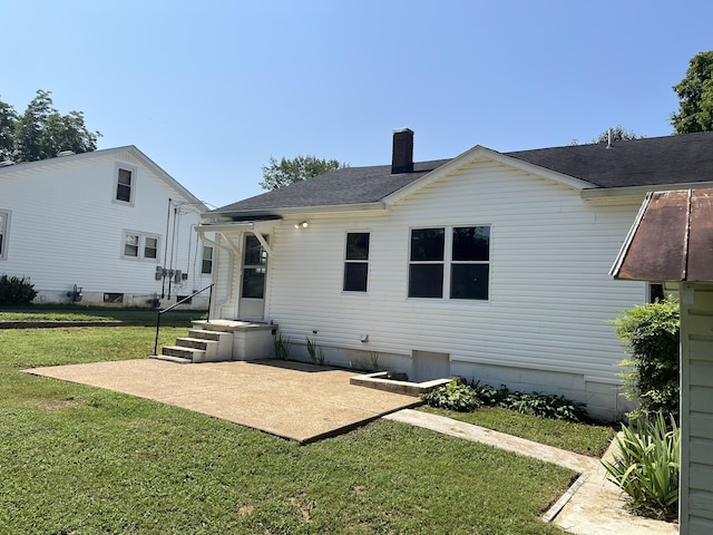538 Lincoln St, Pulaski, TN 38478 - rear view of house with a lawn, a chimney, a shingled roof, and a patio area