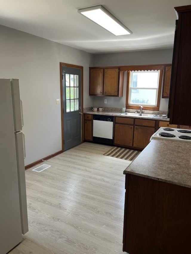 538 Lincoln St, Pulaski, TN 38478 - kitchen featuring white appliances, light wood-type flooring, and brown cabinets