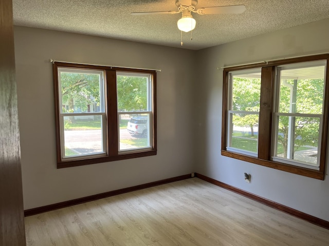 538 Lincoln St, Pulaski, TN 38478 - empty room featuring plenty of natural light, light wood-type flooring, a textured ceiling, and ceiling fan