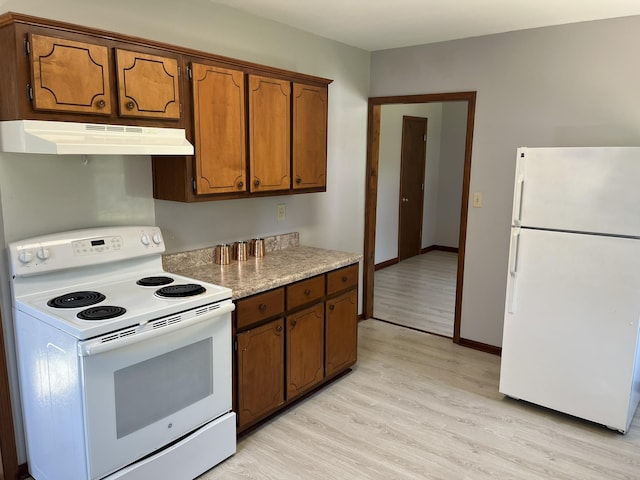 538 Lincoln St, Pulaski, TN 38478 - kitchen featuring white appliances, under cabinet range hood, light wood-style flooring, brown cabinets, and light countertops