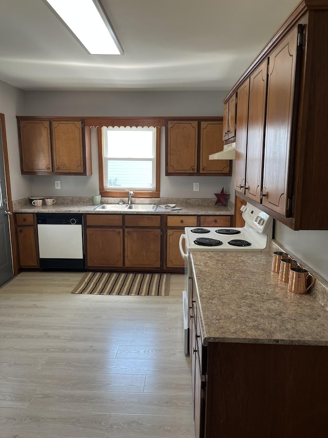 538 Lincoln St, Pulaski, TN 38478 - kitchen featuring white appliances, light wood-style flooring, under cabinet range hood, and brown cabinetry