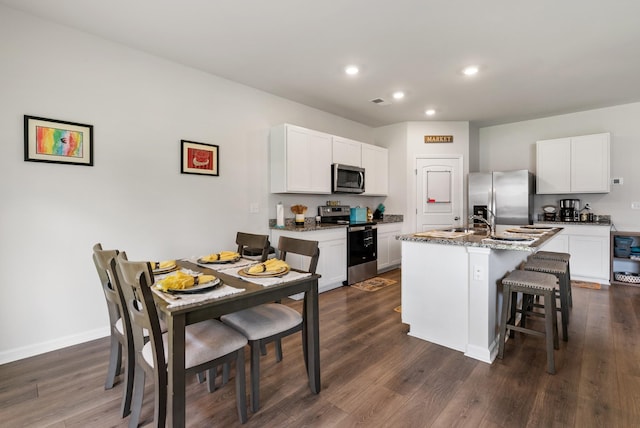125 Stammer Farms Blvd, Chapel Hill, TN 37034 - kitchen featuring stainless steel appliances, recessed lighting, a breakfast bar, a center island with sink, and dark wood-style floors