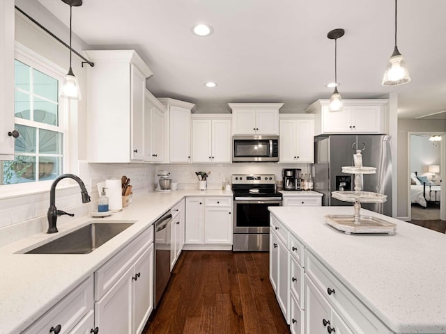 310 Diane Loop, White Bluff, TN 37187 - kitchen featuring stainless steel appliances, white cabinetry, backsplash, light stone countertops, and recessed lighting