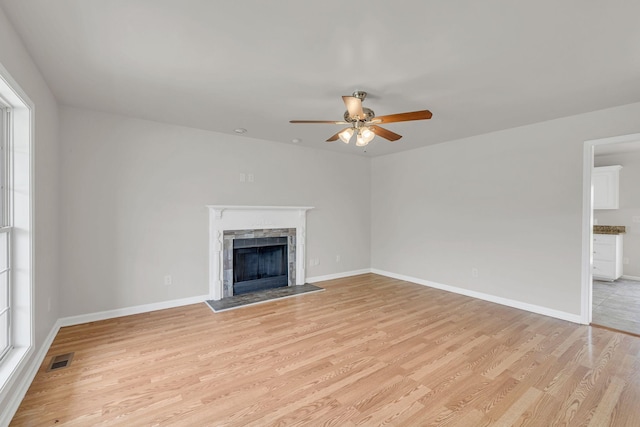 2995 Pipkin Hills Dr, Spring Hill, TN 37174 - unfurnished living room featuring a ceiling fan, light wood-type flooring, and a fireplace