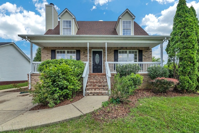 2995 Pipkin Hills Dr, Spring Hill, TN 37174 - view of front of house featuring covered porch, brick siding, a chimney, and roof with shingles