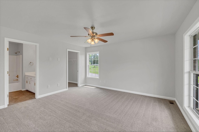 2995 Pipkin Hills Dr, Spring Hill, TN 37174 - unfurnished bedroom with carpet, a spacious closet, ceiling fan, a closet, and ensuite bath