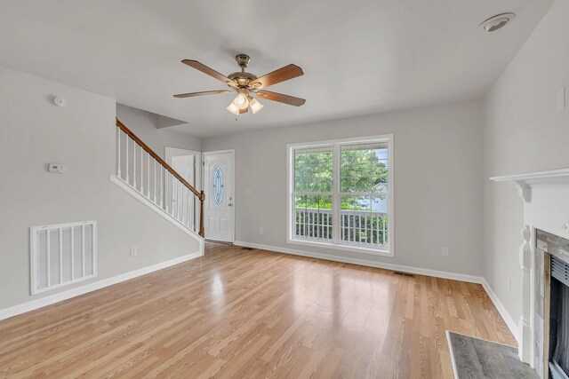 2995 Pipkin Hills Dr, Spring Hill, TN 37174 - unfurnished living room featuring stairway, ceiling fan, a high end fireplace, and light wood-style flooring