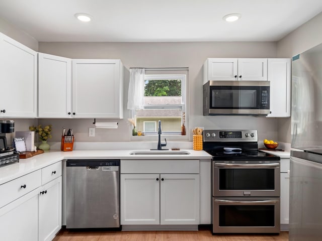 2011 Denham Ave, Columbia, TN 38401 - kitchen with stainless steel appliances, light countertops, white cabinets, and recessed lighting