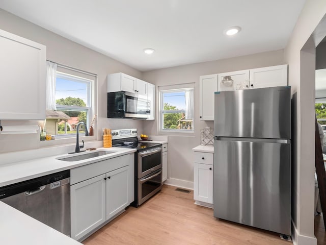 2011 Denham Ave, Columbia, TN 38401 - kitchen featuring stainless steel appliances, white cabinets, light countertops, light wood-style floors, and recessed lighting