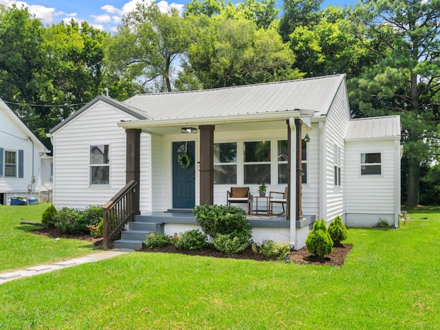 2011 Denham Ave, Columbia, TN 38401 - view of front facade featuring covered porch, a front lawn, and a metal roof