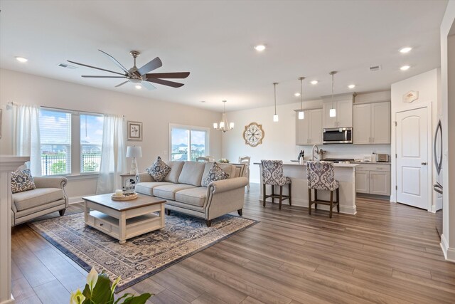 3702 Mathewson Way, Murfreesboro, TN 37128 - living room featuring a ceiling fan, light wood-style floors, recessed lighting, and a chandelier