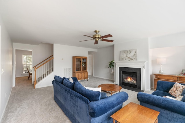 1902 Baileys Trace Dr, Spring Hill, TN 37174 - living room featuring light colored carpet, stairs, a ceiling fan, and a fireplace with flush hearth