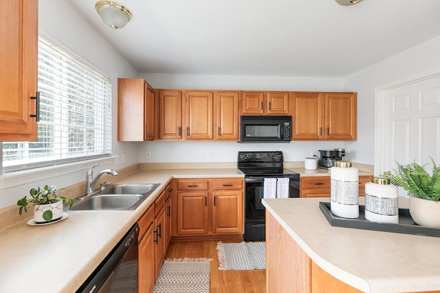 1902 Baileys Trace Dr, Spring Hill, TN 37174 - kitchen featuring black appliances, light wood-style flooring, light countertops, and brown cabinetry