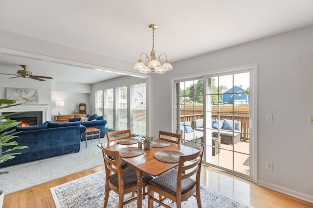 1902 Baileys Trace Dr, Spring Hill, TN 37174 - dining room featuring plenty of natural light, light wood-type flooring, a lit fireplace, and a chandelier