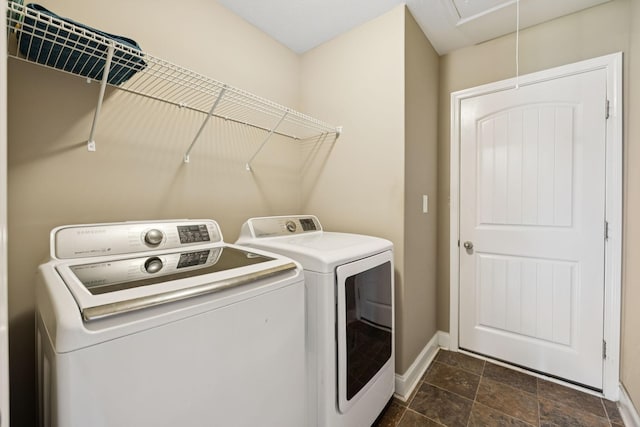 510 Sourwood Dr, Clarksville, TN 37042 - laundry room featuring separate washer and dryer, attic access, and dark stone finish floors