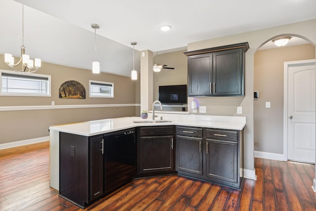 510 Sourwood Dr, Clarksville, TN 37042 - kitchen featuring dishwasher, light countertops, arched walkways, and dark wood finished floors