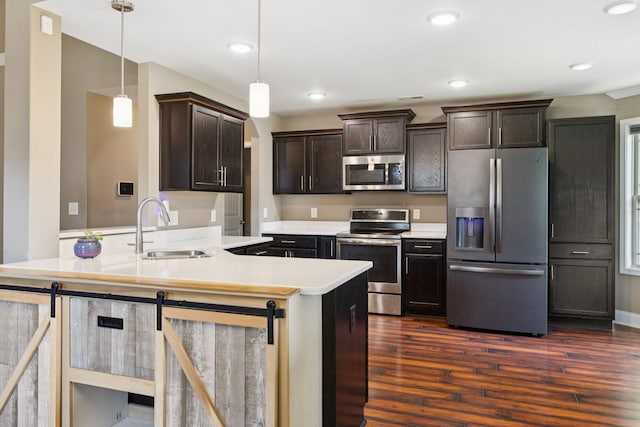 510 Sourwood Dr, Clarksville, TN 37042 - kitchen featuring appliances with stainless steel finishes, dark wood finished floors, dark brown cabinetry, light countertops, and recessed lighting