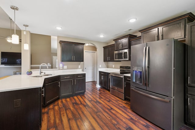 510 Sourwood Dr, Clarksville, TN 37042 - kitchen featuring stainless steel appliances, arched walkways, dark wood-type flooring, a ceiling fan, and light countertops